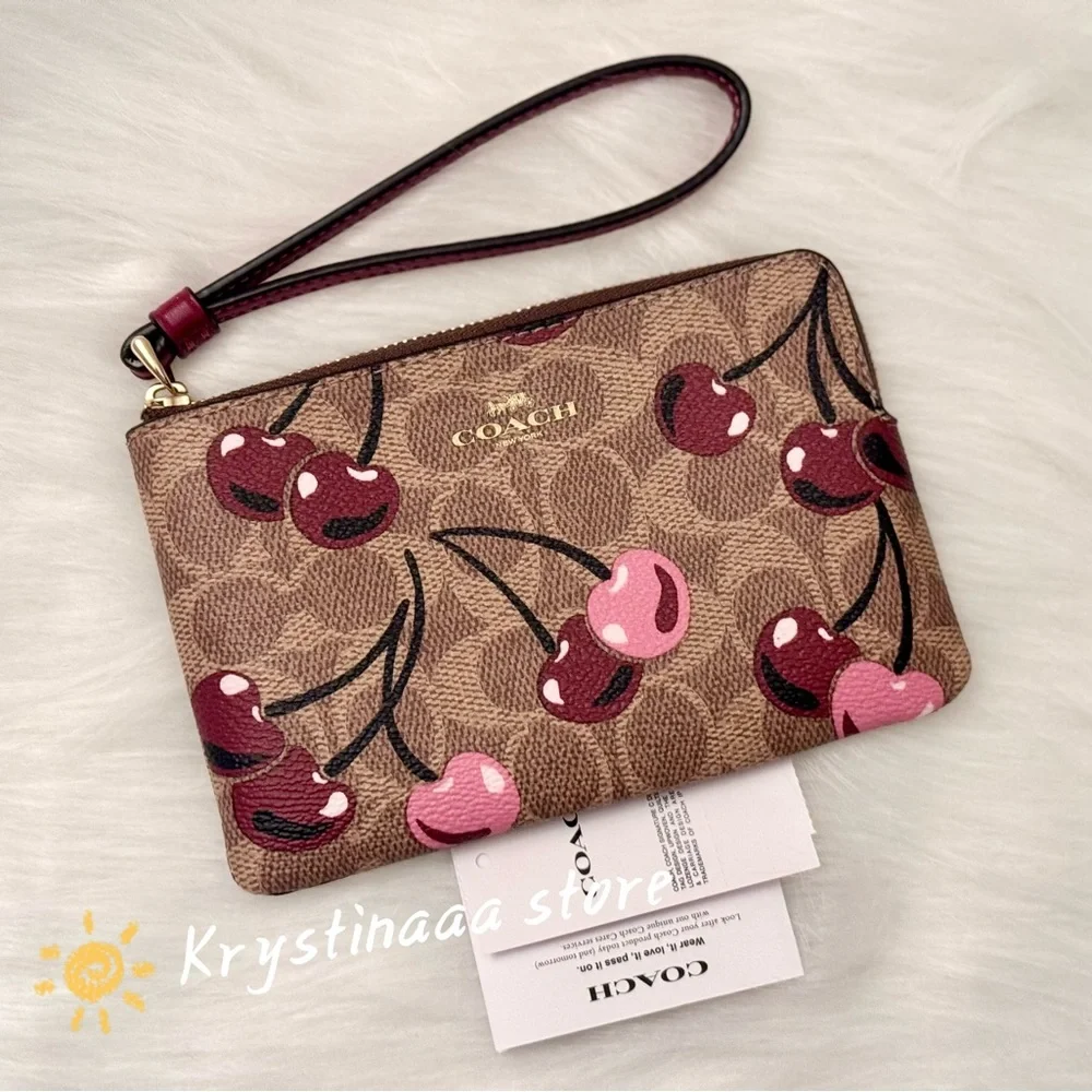 Coach Corner Zip Wristlet In Signature Canvas With Cherry Print CZ450